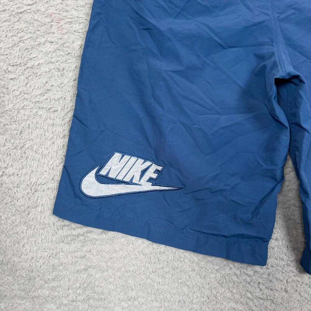 Vintage Nike Boys Blue Nylon Athletic Shorts White Side Stripe Logo Size Medium
